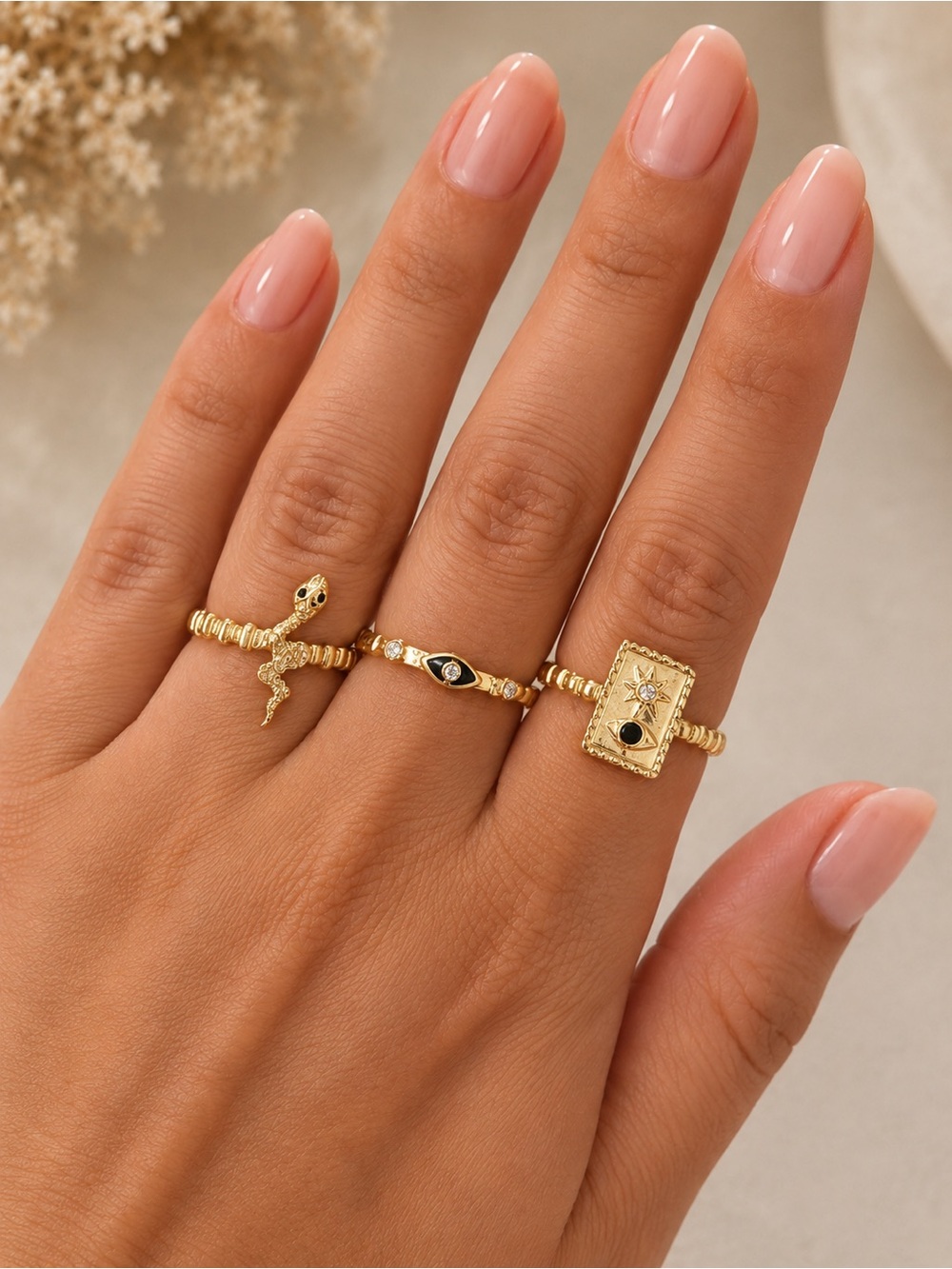Goldtone ring set of 3. Evil’s eye, Star, snake.